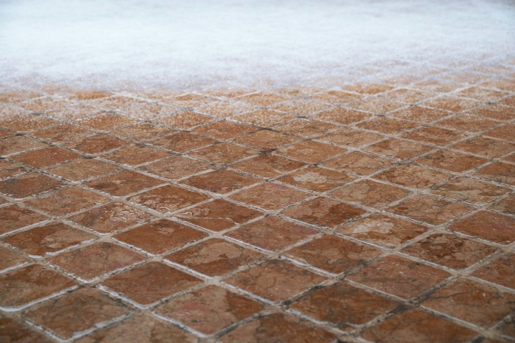 Mosaic stone floor covered with snow